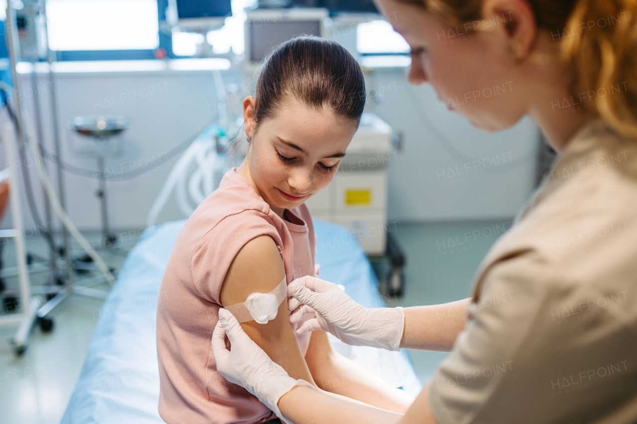 Nurse is caring for the injection wound after vaccination.