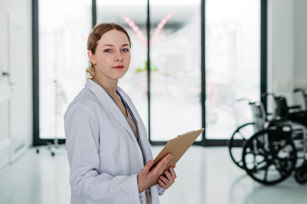 Focused young doctor in lab coat during shift.