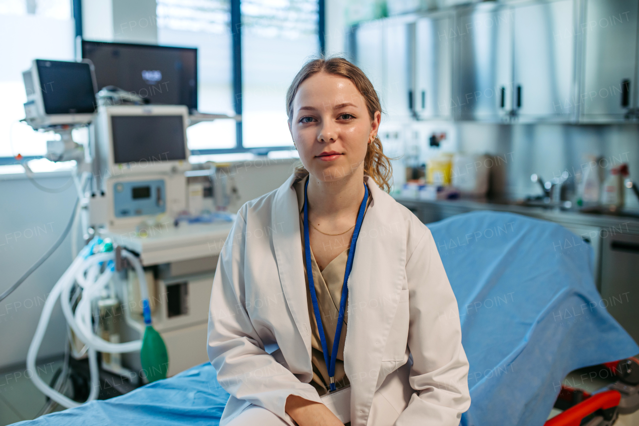 Confident young doctor holding patient chart in hospital room.