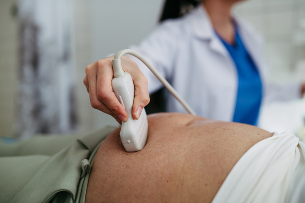 Close up of abdominal ultrasound on elderly woman. Preventive care.