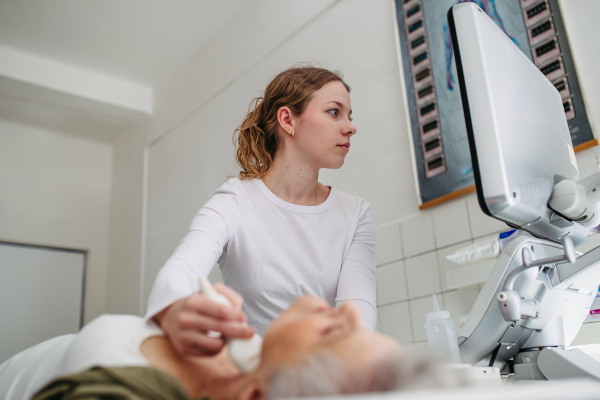 Female patient undergoing thyroid ultrasound examination. Lymp node sonography.