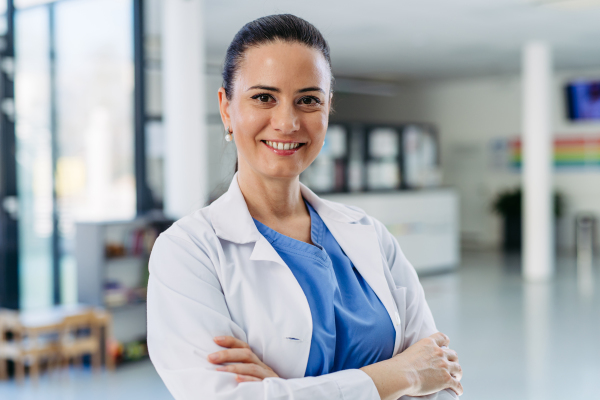Portrait of Confident female doctor in hospital corridor.