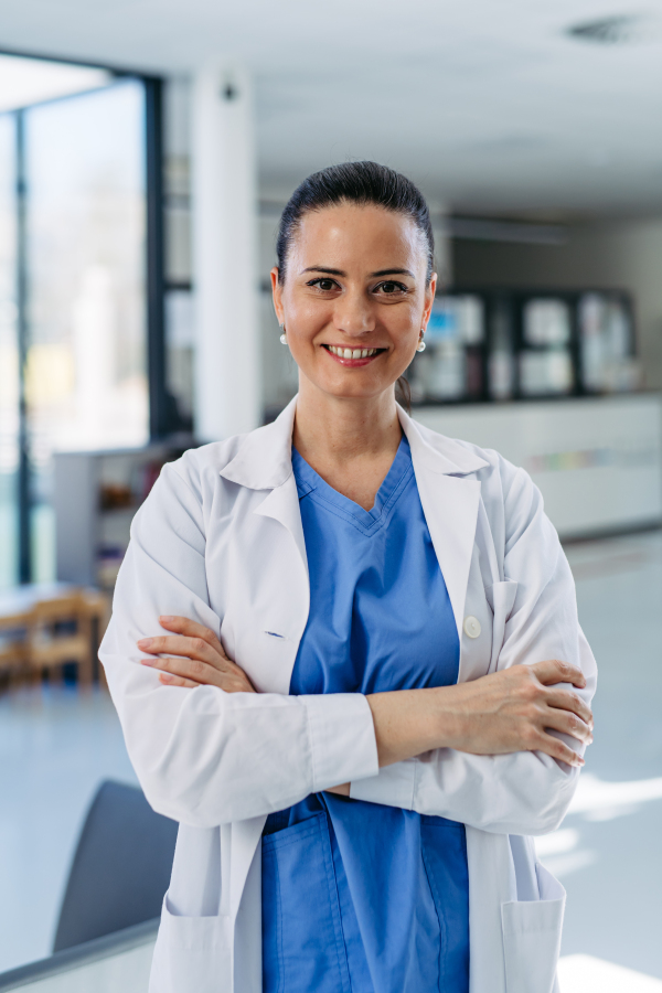 Portrait of Confident female doctor in hospital corridor.