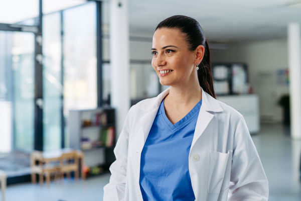 Portrait of Confident female doctor in hospital corridor.