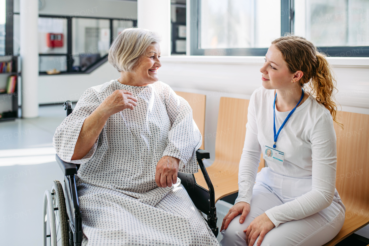 Doctor and elderly patient having conversation in hospital setting