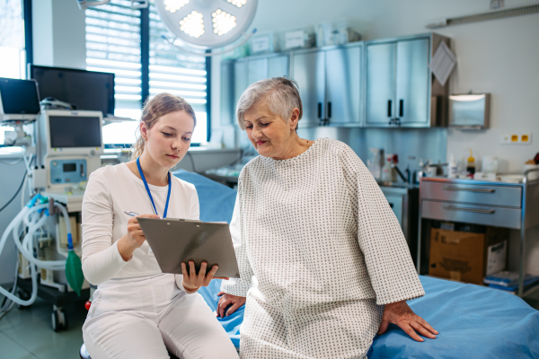 Geriatrician talking with senior patient during check-up. Medical consultation.