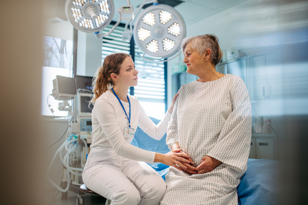 Geriatrician talking with senior patient during check-up. Medical consultation.