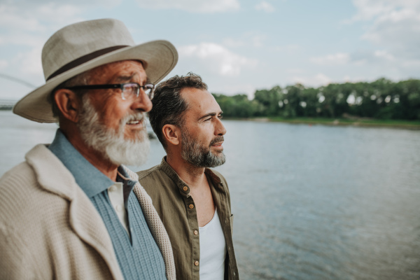 Senior dad and middle-aged son enjoying nature together. Fathers day concept.