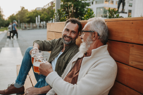 Father and son enjoHappy father and son sharing drinks on a sunny day. Fathers day concept.