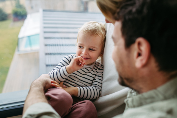Playful father playing with little young son.