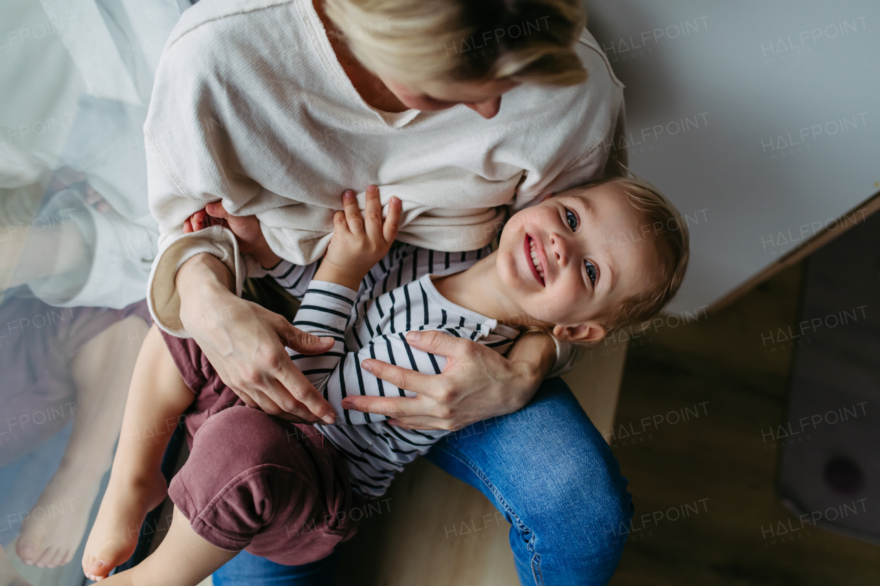 Beautiful mother hugging little young son.