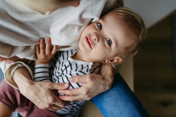 Beautiful mother hugging little young son.