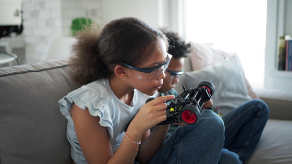 Kids building their first homemade robot at home. Educational robotic kit for children.
