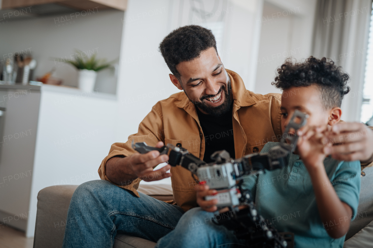Father and son exploring STEM, robotics, and technology together at home