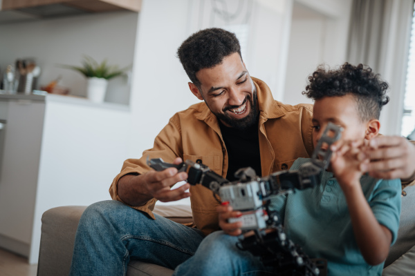 Father and son exploring STEM, robotics, and technology together at home