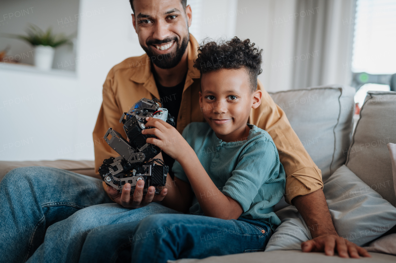Father and son exploring STEM, robotics, and technology together at home