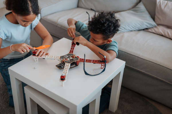 Kids playing with drone at home. Educational robotic kit for children.