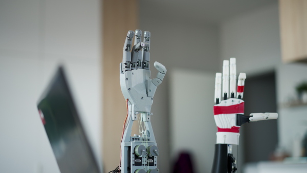 A close up of a robotic arm being programmed at home by engineer. Robotics concept.