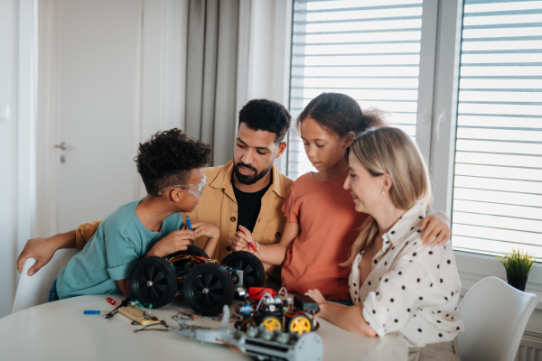 Parents encouraging their children to explore robotics and technical skills.