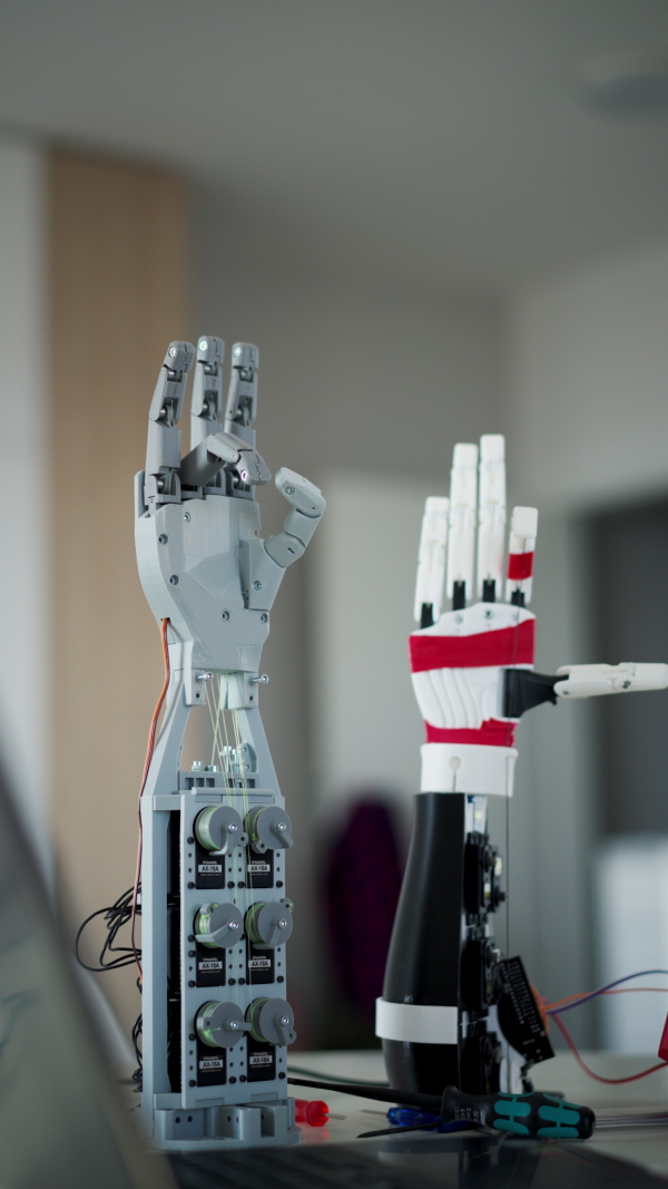 A close up of a robotic arm being programmed at home by engineer. Robotics concept.