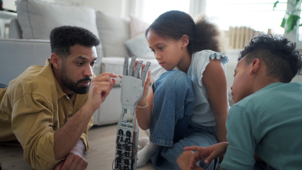 Father teaching kids about STEM, robotics, and discussing technology at home.