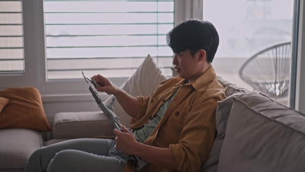 Young engineer building a robotic arm at home. Robotics concept.