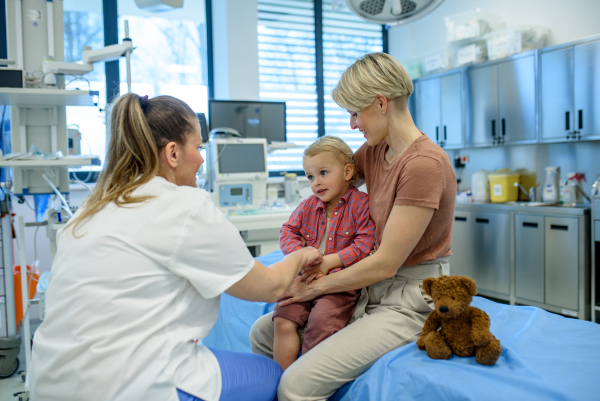 Female pediatrician examing little boy during preventive health check up.