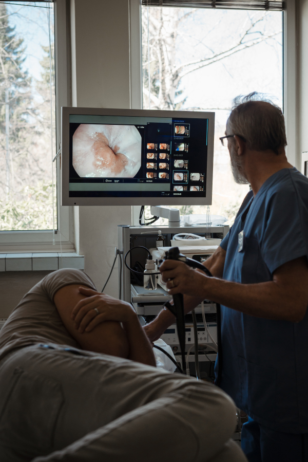 Doctor looking at monitior during gastroscopy procedure, examining upper digestive tract. Medical procedure.