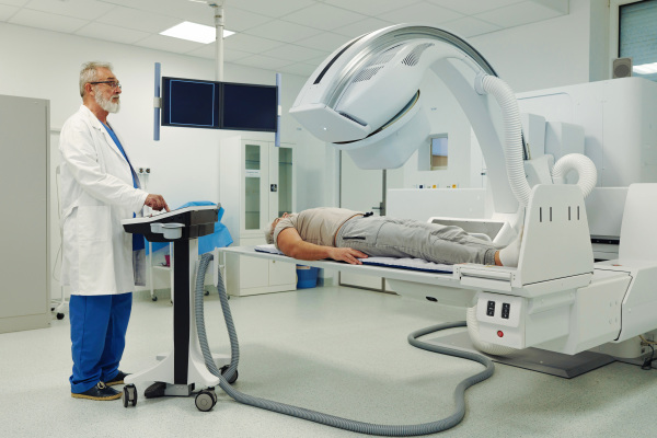 Male patient undergoing CT scan examination in hospital., hospital setting
