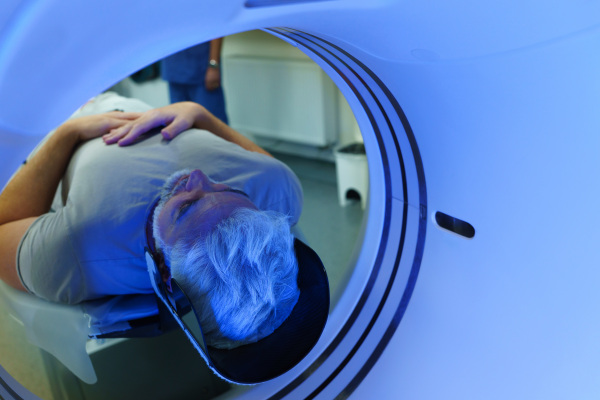 Male patient undergoing CT scan examination in a hospital.