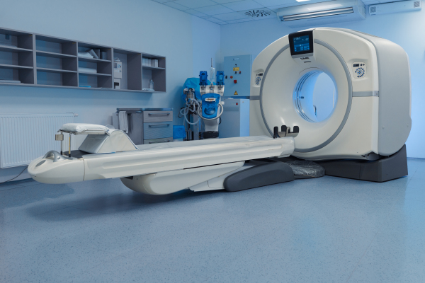 Modern CT scanner in empty radiology exam room. Hospital setting.