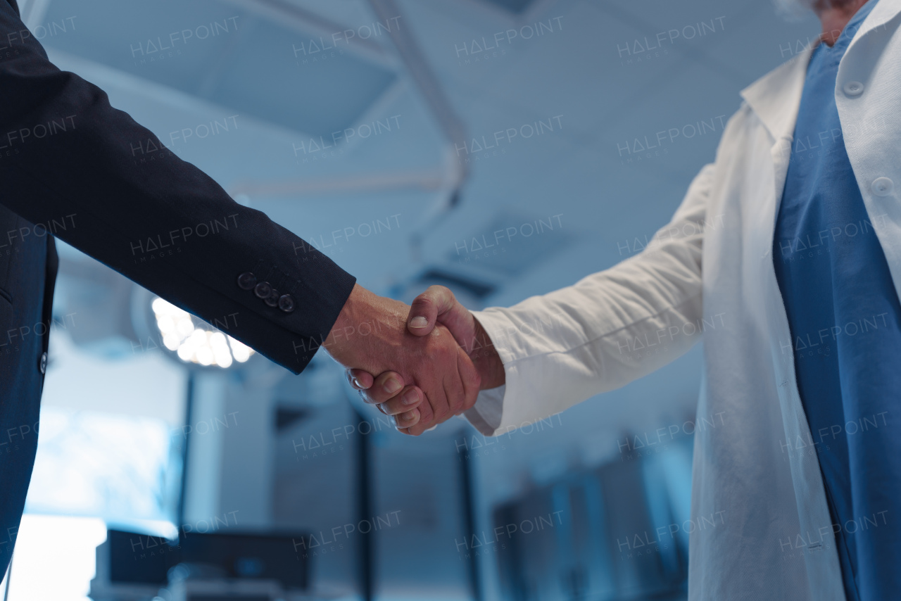 Hospital business handshake in medical environment. Strategic collaboration in medical industry.