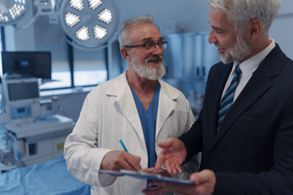 Doctor signing contract with pharmaceutical representative, successful deal.
