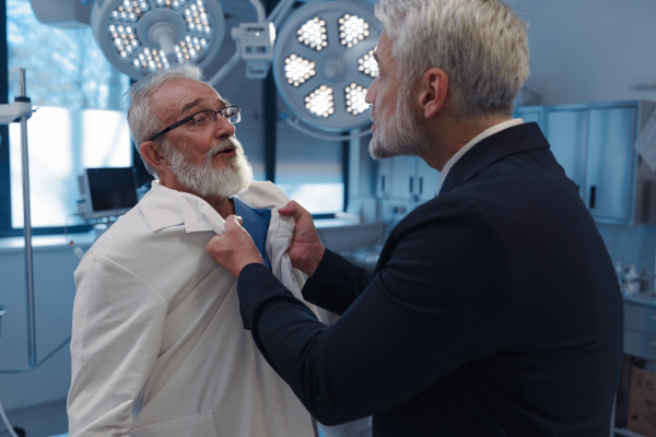 Violence against health workers. Patient is aggressive, have conflict with doctor, holding him by coat.