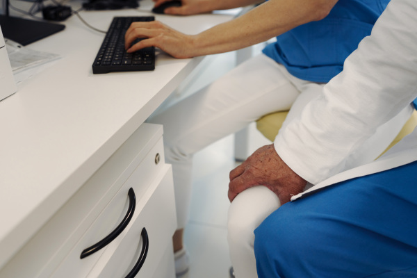 Inappropriate behavior of doctor, holding nurse by thigh. Workplace harassment in hospital.