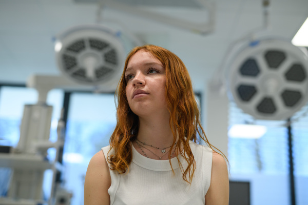 Teenage girl waiting for medical examination in hospital. Portrait of adolescent patient.