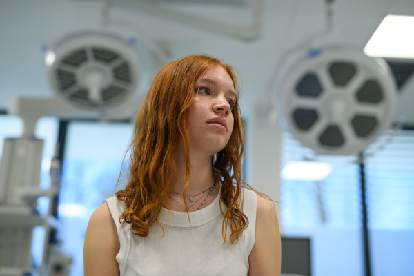 Teenage girl waiting for medical examination in hospital. Portrait of adolescent patient.