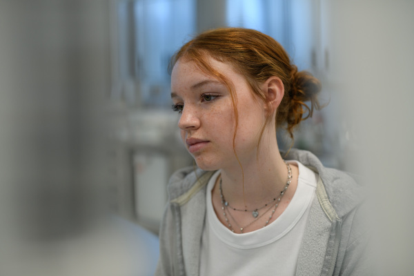 Teenage girl waiting for medical examination in hospital. Portrait of adolescent patient.