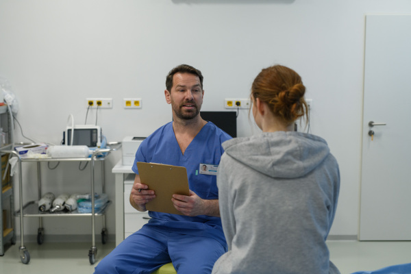 Teenage girl confiding in female doctor about personal and health problems.