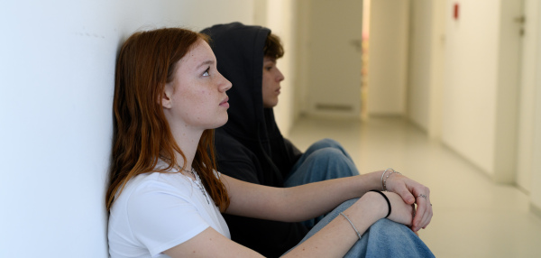 Boy and girl waiting in hospital waiting room for medical examination. Banner with copy space.