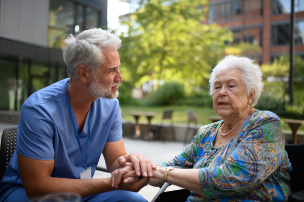 Healthcare worker listening to senior patients problems. Concept of emotional support.