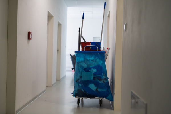 Hospital cleaning cart with supplies in corridor