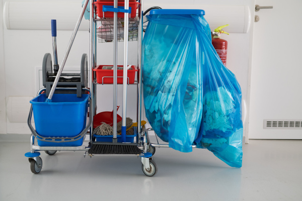 Hospital cleaning cart with supplies in corridor