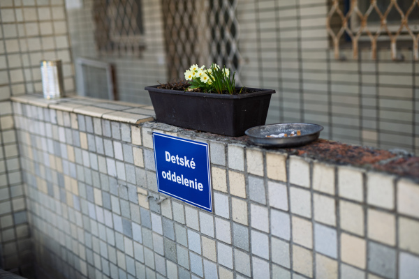 Sign for children's hospital department with flower pot and ashtray