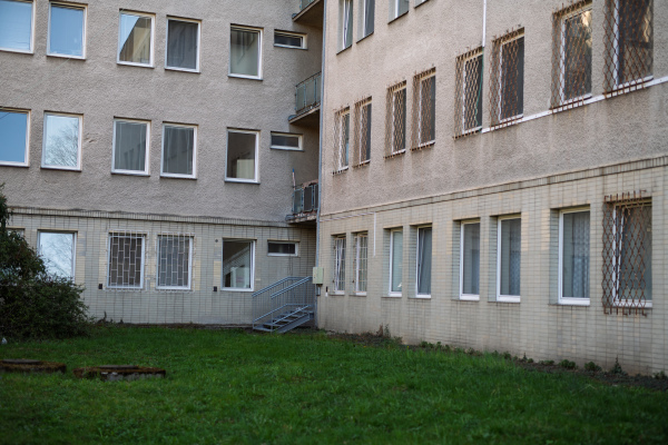 Old hospital building with barred windows and worn facade