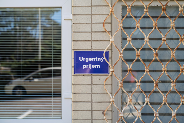 Emergency department sign on hospital building in Slovakia.