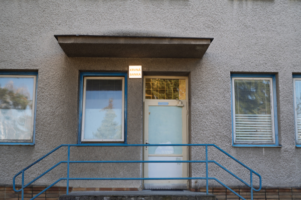 Entrance to outdated hospital blood bank with old doors and windows