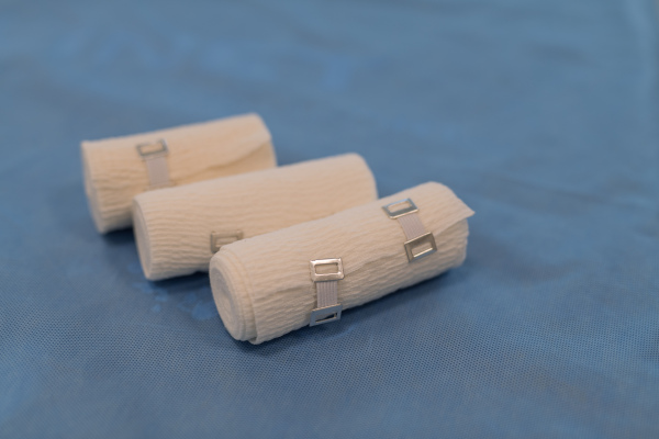 Rolled medical bandages on blue hospital fabric