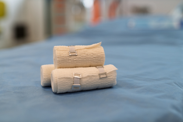 Rolled medical bandages on blue hospital fabric