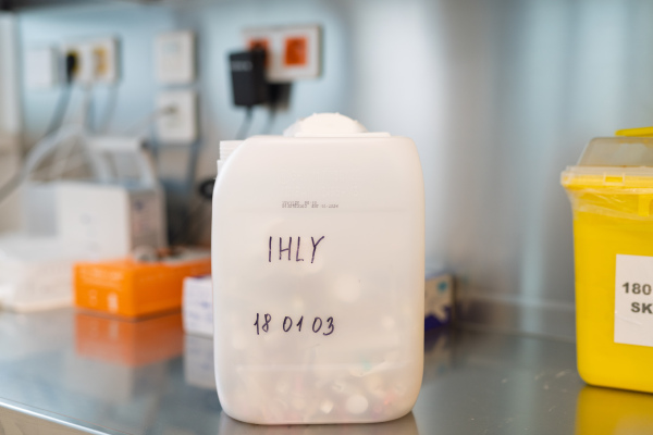 Disposal of injection needle in marked container in clinic